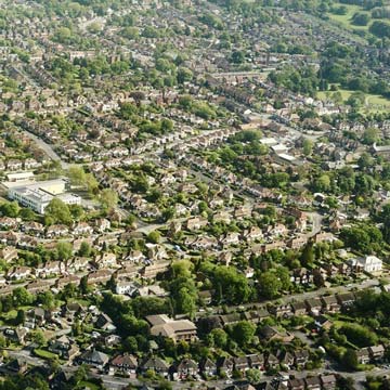 Aerial view of UK residential suburb requiring lease plans for Land Registry leaseholder records.